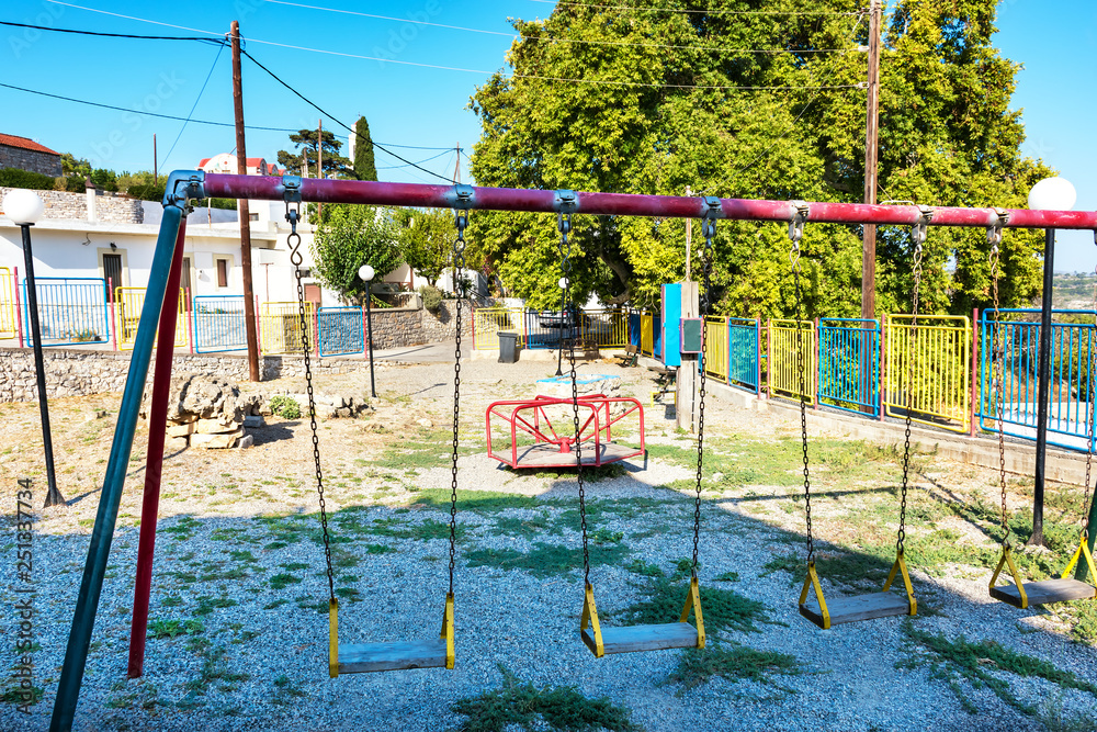 Fototapeta premium Old empty playground in Greek village on Island of Rhodes (Rhodes, Greece)
