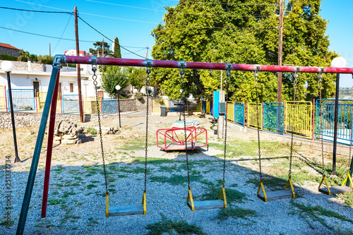 Old empty playground in Greek village on Island of Rhodes (Rhodes, Greece)