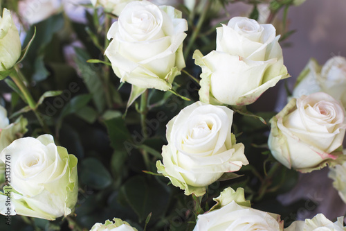 Large white roses in a bouquet. The concept of selling flowers