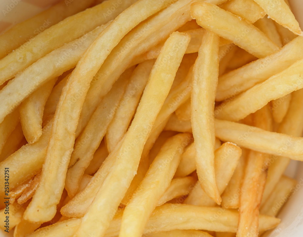 French fries in a paper cup. Selective focus and shallow depth of field. French fries in a paper cup. Selective focus and shallow depth of field.