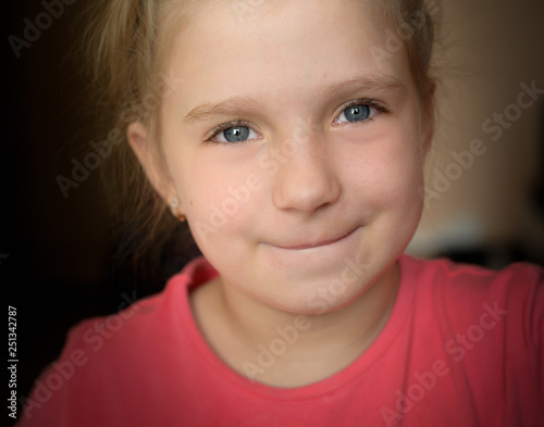 Close-up portrait of adorable smiling little girl. Selective focus with shallow depth of field.