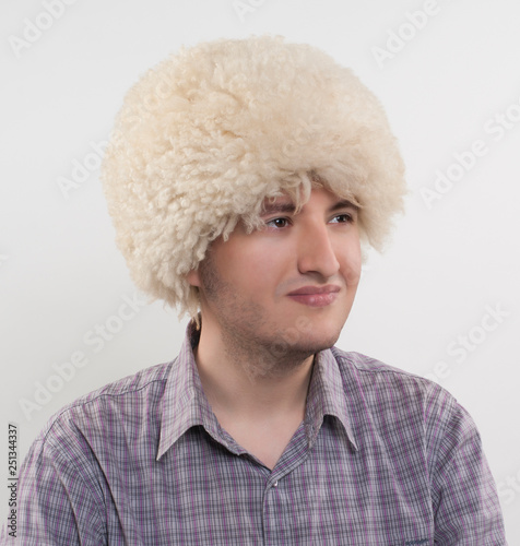 white Caucasian headdress on a man's head. photo