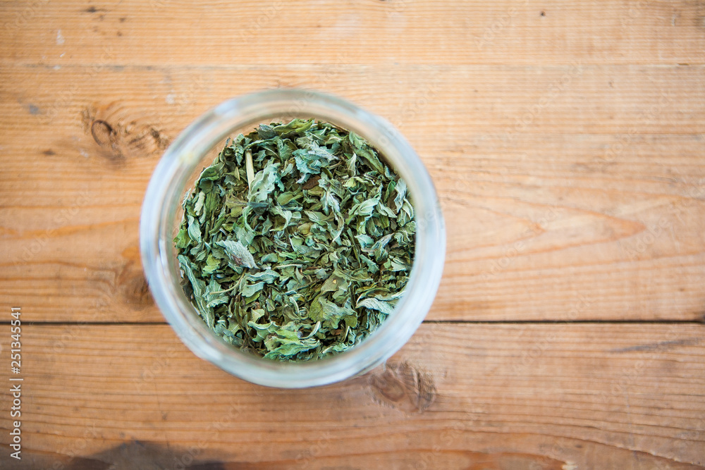 Green tea (herb) on a wood ground Green tea (herb) on a wood ground