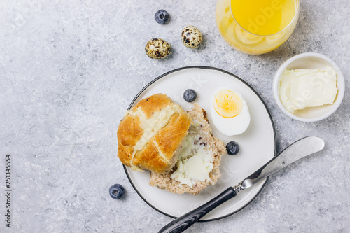 Traditional Easter treats cross buns wwith fresh butter photo