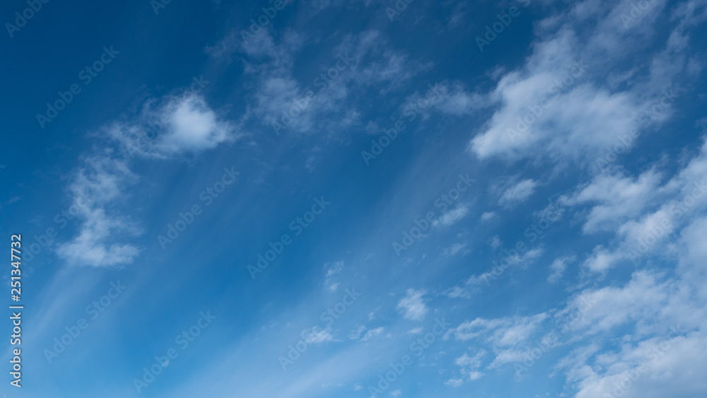 Cirrus clouds scattered in a clear blue sky. Cirrus clouds scattered in a clear blue sky.