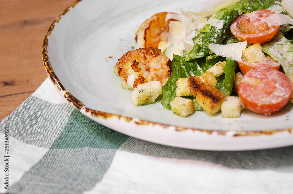 Shrimp Caesar salad with Parmesan cheese, croutons and lettuce Shrimp Caesar salad with Parmesan cheese, croutons and lettuce