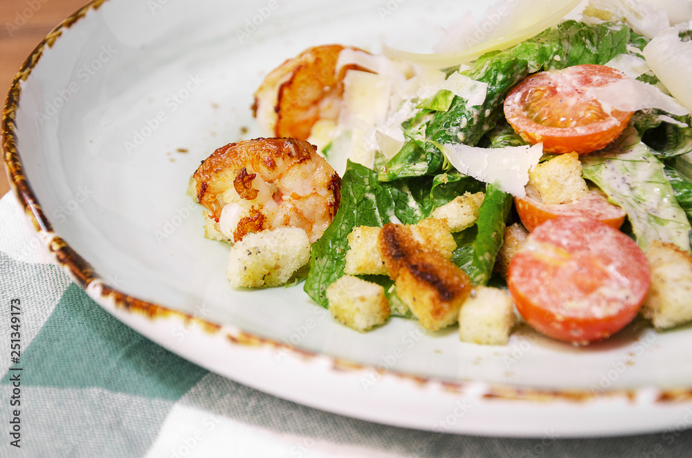 Shrimp Caesar salad with Parmesan cheese, croutons and lettuce