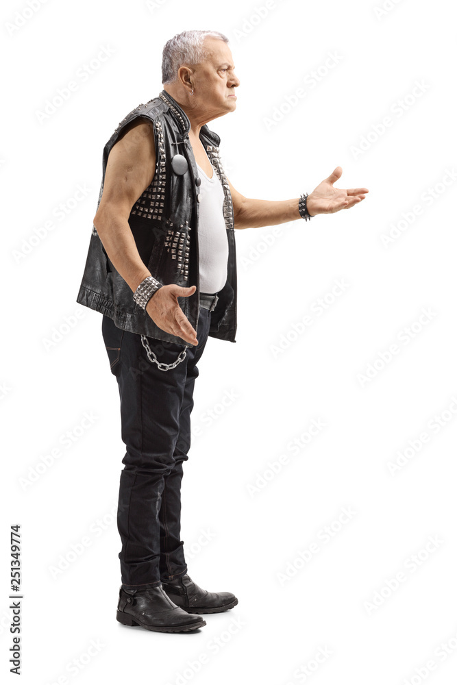 Mature man in a leather vest with an angry expression gesturing with hand