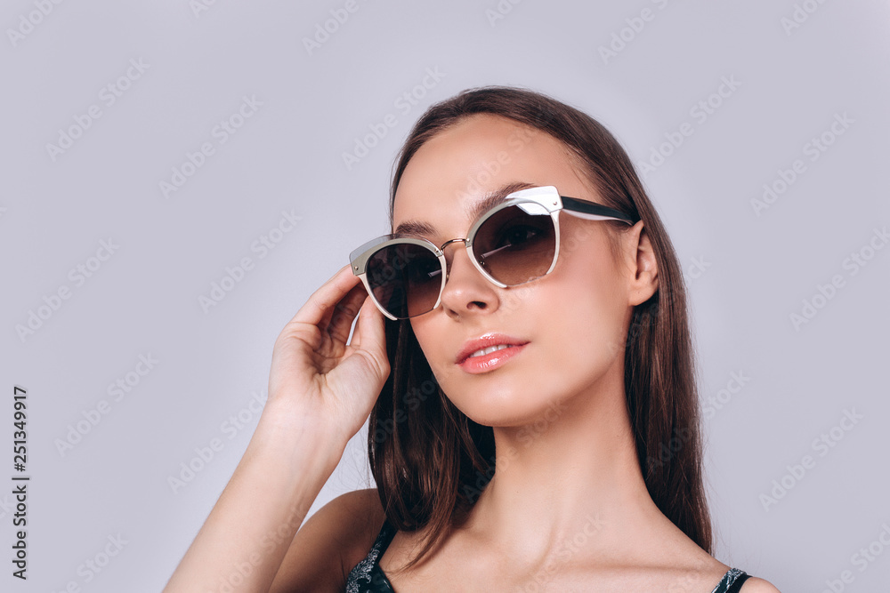 Beautiful smart serious fashionable professional model posing in studio. Business, fashion, beauty concept Beautiful smart serious fashionable professional model posing in studio. Business, fashion, beauty concept