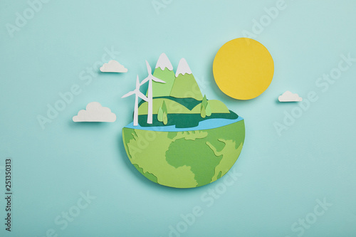 Fototapeta Naklejka Na Ścianę i Meble -  Top view of paper cut planet with renewable energy sources on turquoise background, earth day concept