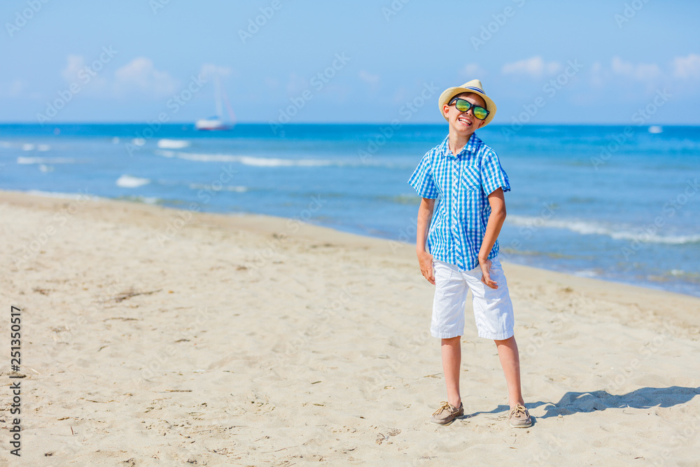 Happy boy having fun on tropical beach