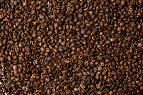 coffee grains on black background. view from above