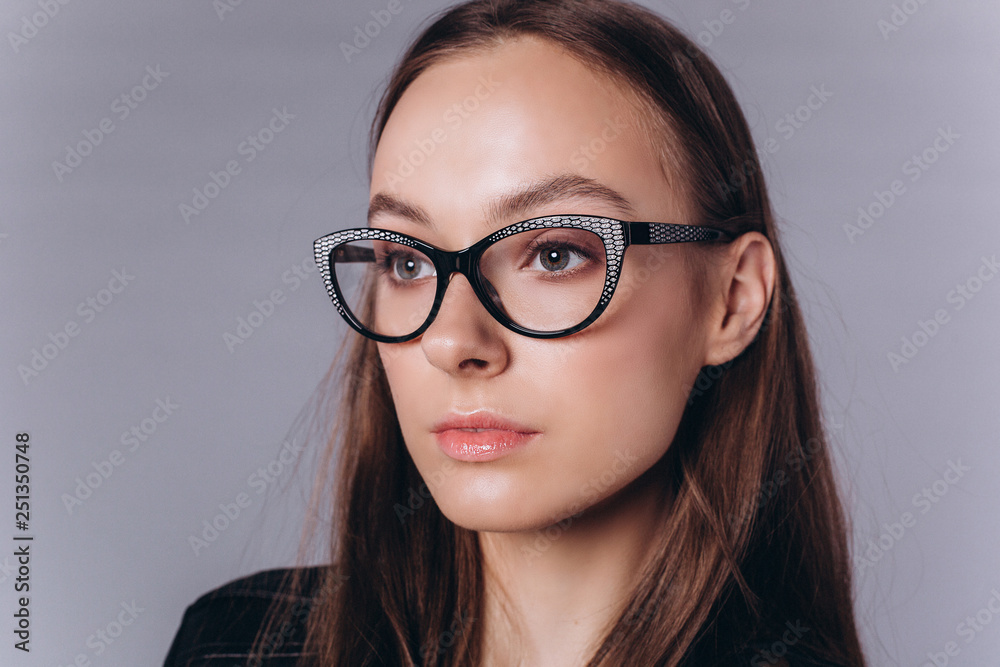 Beautiful smart serious fashionable professional model posing in studio. Business, fashion, beauty concept Beautiful smart serious fashionable professional model posing in studio. Business, fashion, beauty concept