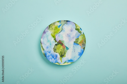 Fototapeta Naklejka Na Ścianę i Meble -  top view of planet picture on turquoise background, earth day concept