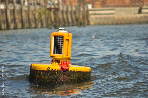 yellow buoy at Hamburg harbour with barnacles