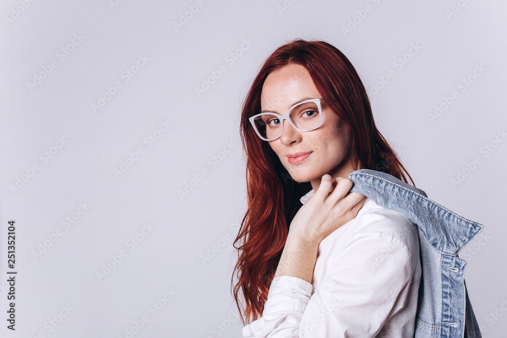 Portrait of young smart beautiful fashionable caucasian student girl with red headed hairstyle on white background. Business, knowledge, education concept Portrait of young smart beautiful fashionable caucasian student girl with red headed hairstyle on white background. Business, knowledge, education concept