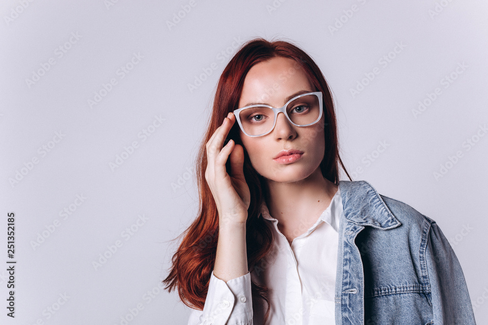 Portrait of young smart beautiful fashionable caucasian student girl with red headed hairstyle on white background. Business, knowledge, education concept Portrait of young smart beautiful fashionable caucasian student girl with red headed hairstyle on white background. Business, knowledge, education concept