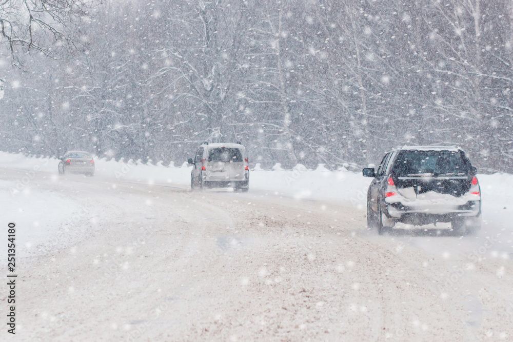 Winter, snow, Blizzard, poor visibility on the road. Car during a Blizzard on the road with the headlights.