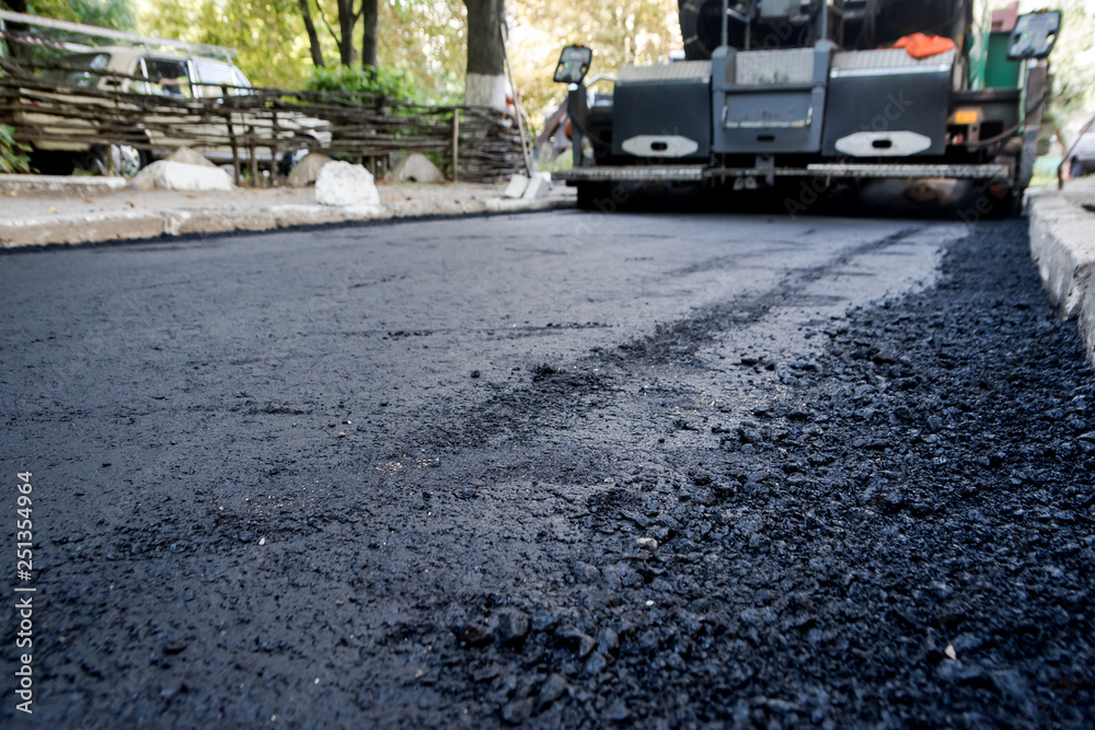 Obraz premium Laying of new asphalt. The new road. Road repair street.