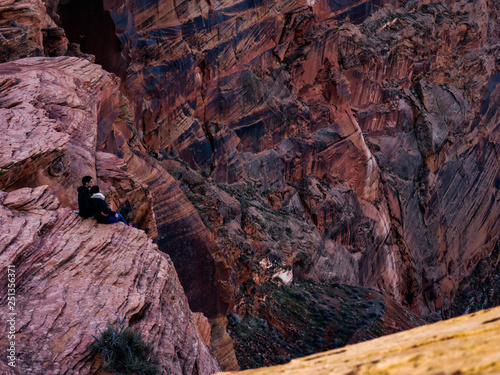 Couple Sitting on the Edge of Glenn Canyon, Arizona, USA