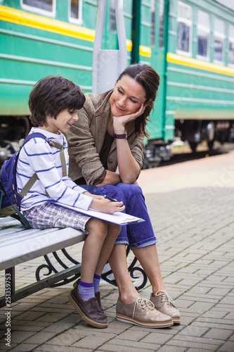mother and son on railroad station