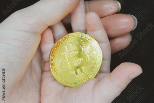 bitcoin gold coin in the hands of mother and child