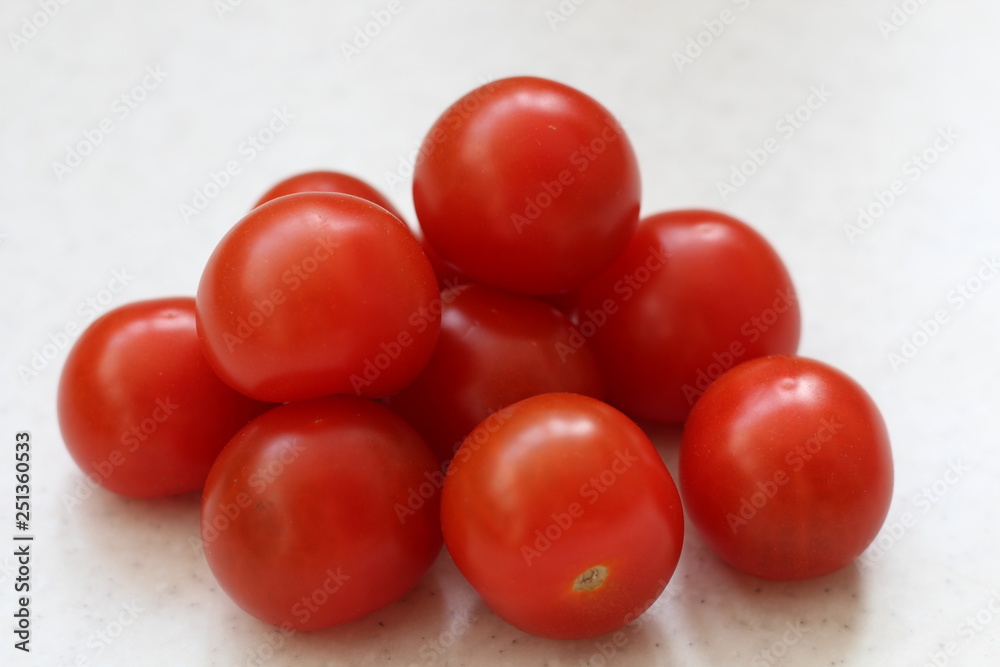 bunch of Cherry red tomatoes isolated on table. bunch of Cherry red tomatoes isolated on table.
