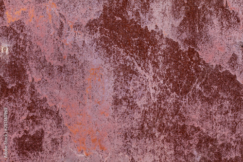 Old painted metal surface. Rusty metal, peeling paint, red tones. Worn metallic iron panel. © Sergey