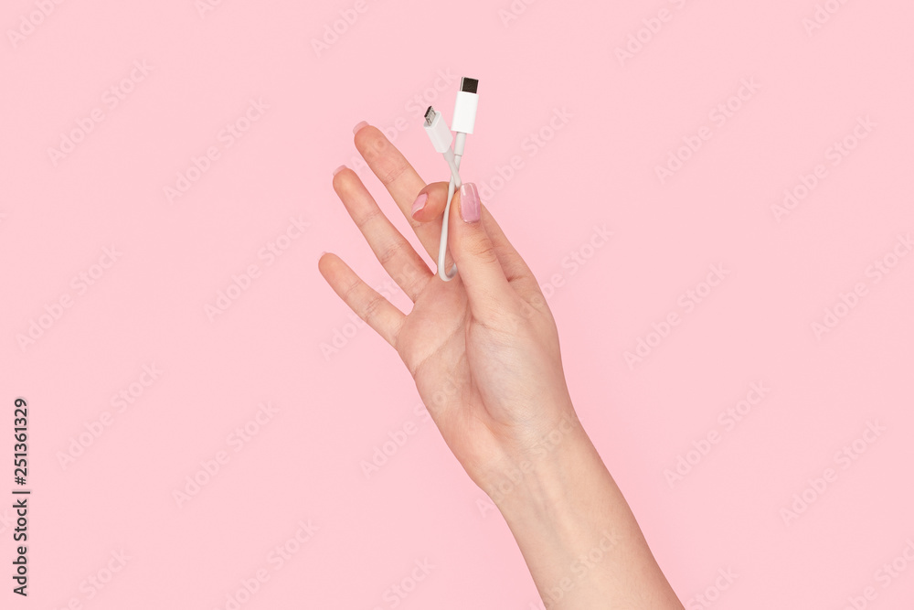 Woman showing white cable adapter Woman showing white cable adapter