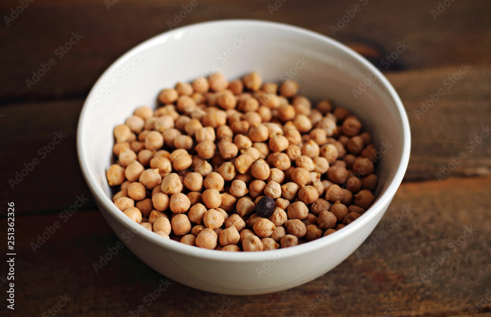 Bowl of chickpeas on wooden table Bowl of chickpeas on wooden table