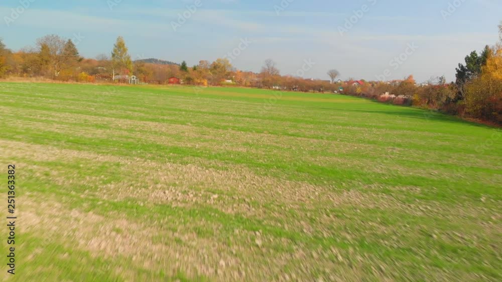 Drone flight above green field in the country, low altitude, agricultural areas, autumn season. Drone flight above green field in the country, low altitude, agricultural areas, autumn season.