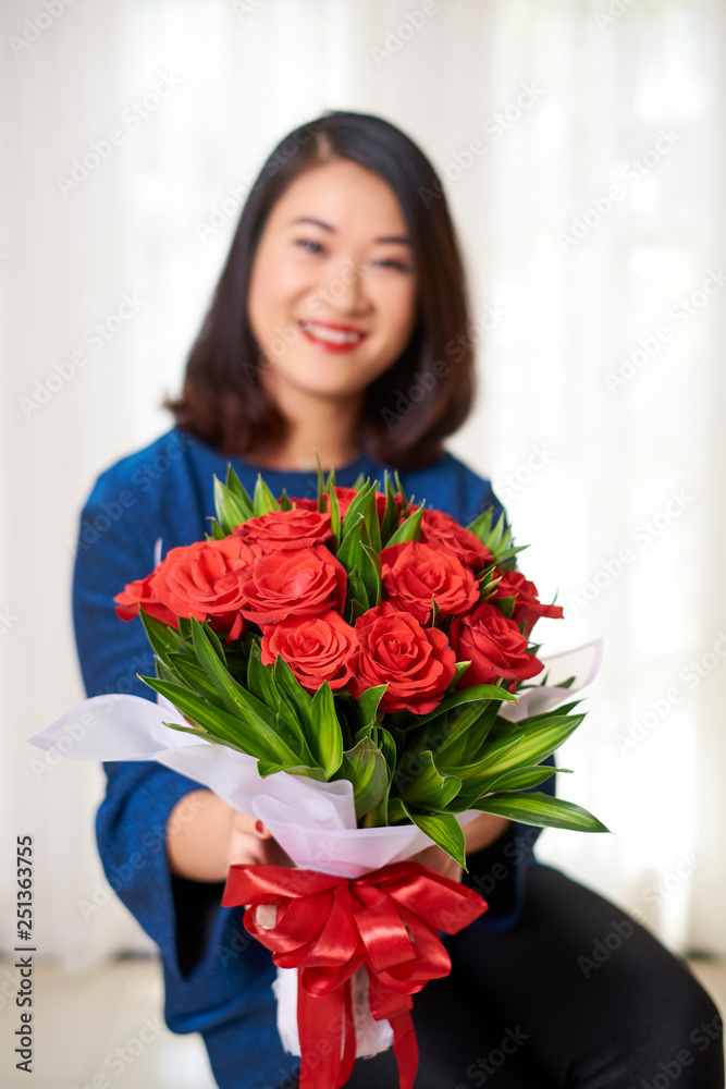 Woman giving a flower bouquet Woman giving a flower bouquet
