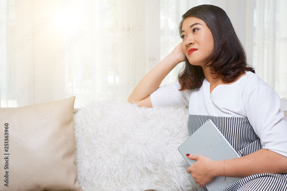 Woman resting at home with book