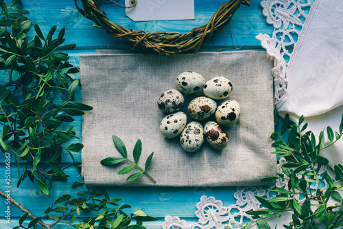 Easter composition with  quail eggs on color wooden background Space for text