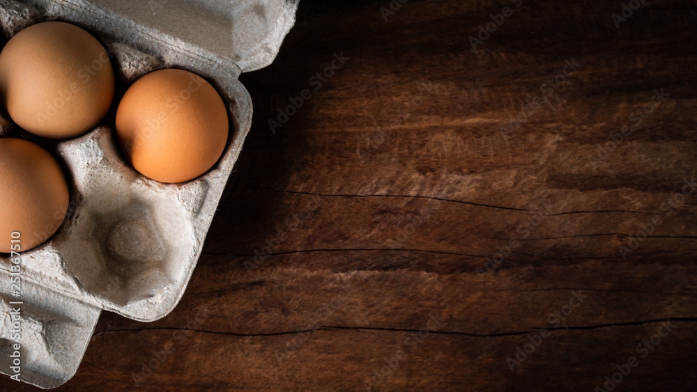 Fresh brown eggs in a carton box was placed on a wooden table to prepare food. Have copyspace to enter text. In aspect ratio 16: 9. Useful for health and easy to find according to the supermarket. Fresh brown eggs in a carton box was placed on a wooden table to prepare food. Have copyspace to enter text. In aspect ratio 16: 9. Useful for health and easy to find according to the supermarket.