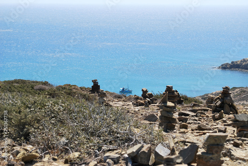 Pyramids of stones on the hill against the background of the sea, Prasonisi, the island of Rhodes, Greece