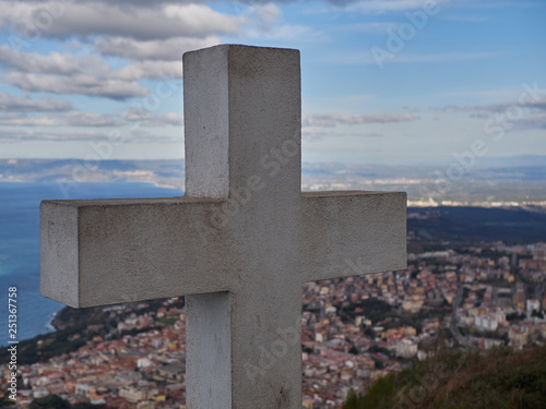 Cross with city in the background