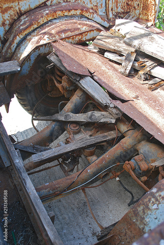 Close-up of transmission and remnants of a wooden body of an old rusty pickup truck, Rhodes Island, Greece