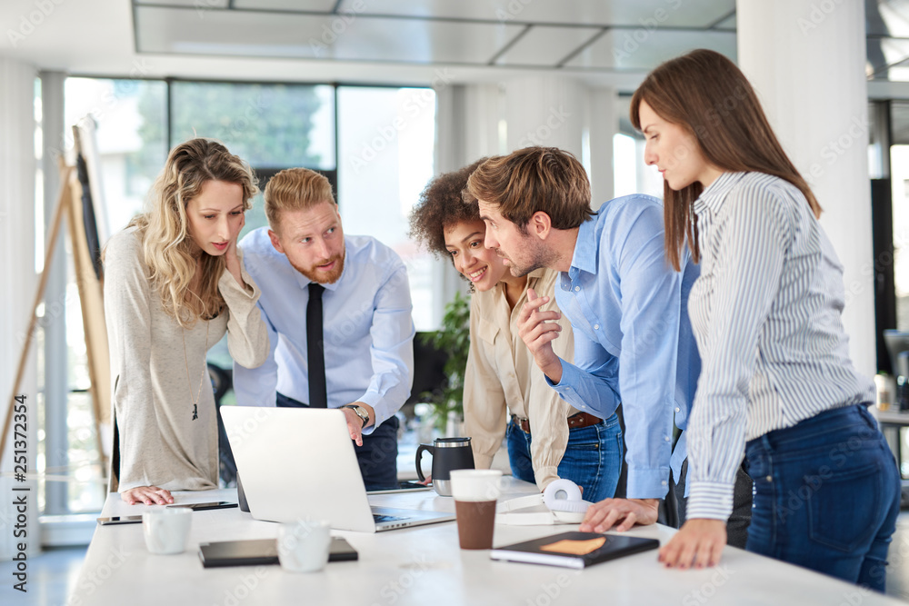 Obraz premium Small group of business people standing at office and solving problem at meeting. Multi cultural group.