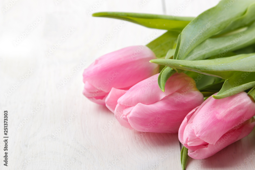 A bouquet of beautiful pink tulips flowers on a white wooden table. Spring. holidays. close-up A bouquet of beautiful pink tulips flowers on a white wooden table. Spring. holidays. close-up