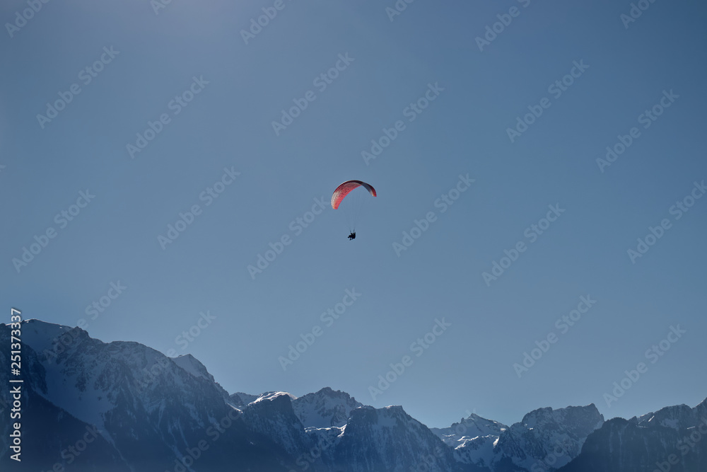 Paraglider tandem flying over alpine mountains. Paraglider tandem flying over alpine mountains.