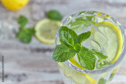 A glass of cool water with ice, lemon and mint. Selective focus. refreshing summer drink close-up. lemon and water.