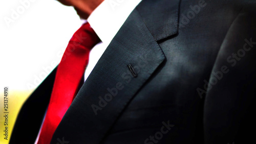 Fotografiet a black business suit jacket with white shirt and red tie, man neck and chest close up texture background with copy space