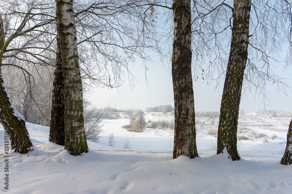 Frozen snow covered river in a winter landscape Frozen snow covered river in a winter landscape