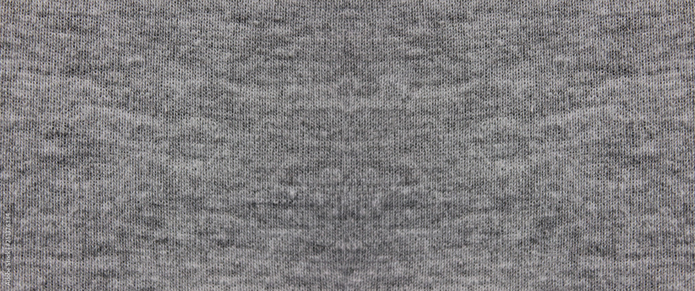 Gray fabric texture background of dark grey colored shirt. Cloth
