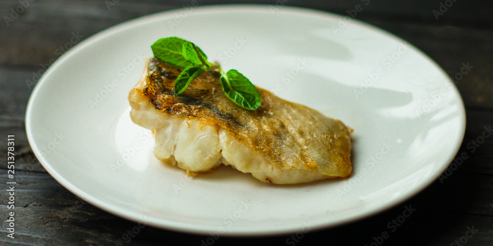 Fish, fried seafood (white fish on the plate). Food background Fish, fried seafood (white fish on the plate). Food background