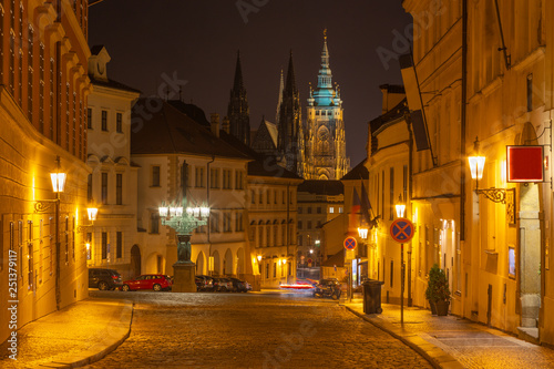 Prague - The St. Vitus cathedral and the Loret    nsk     street at night..