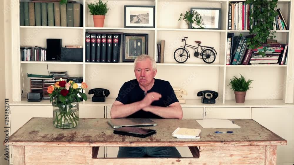 Overwhelmed, funny, senior man sitting by table at home Overwhelmed, funny, senior man sitting by table at home