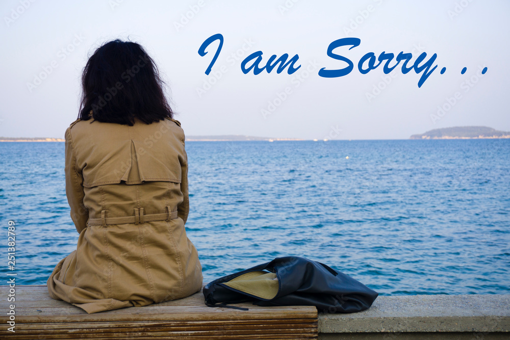 Sad woman feeling lonely, sitting on beach and watching distant seascape  horizon. Time to go and