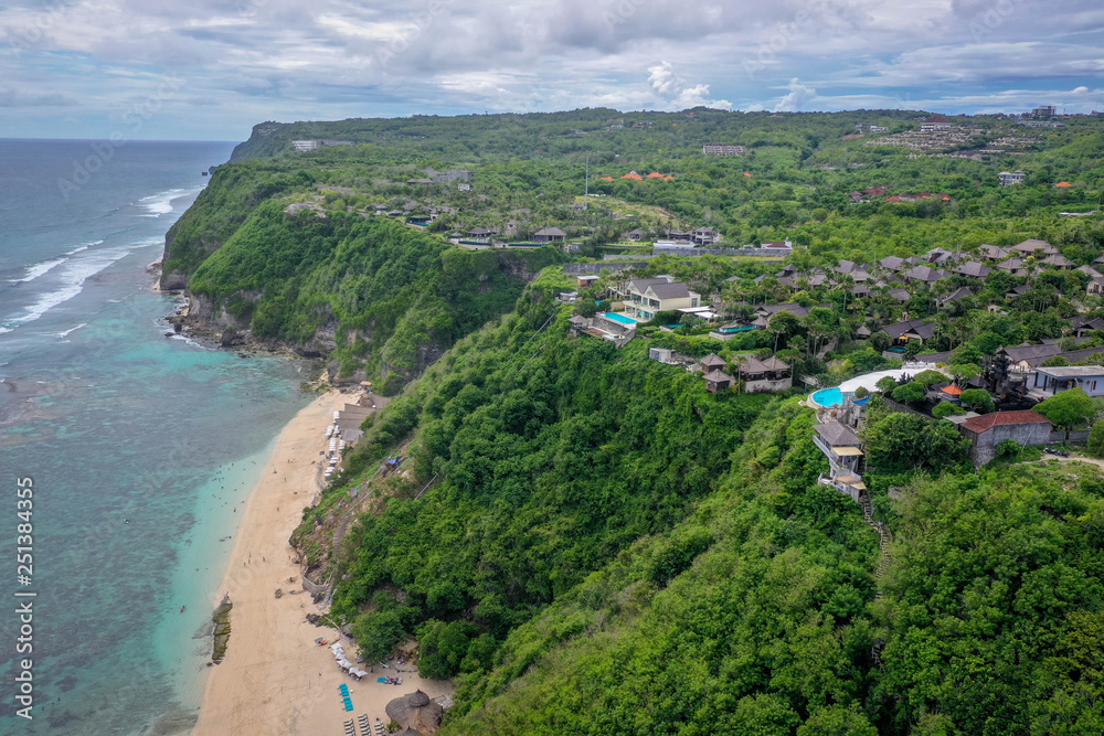 Tropical beach with high green cliffs, aerial view, Melasti beach, Bali, Indonesia Tropical beach with high green cliffs, aerial view, Melasti beach, Bali, Indonesia